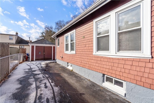 view of home's exterior featuring a storage unit