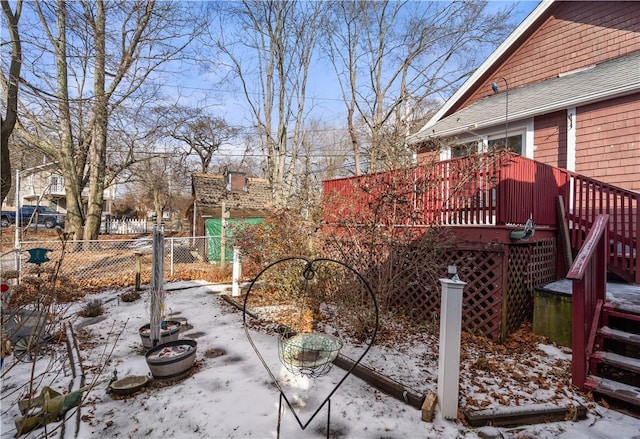 yard covered in snow featuring a wooden deck