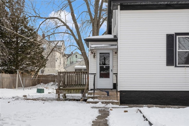 view of snow covered property entrance