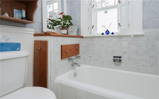 bathroom featuring a bathtub and toilet