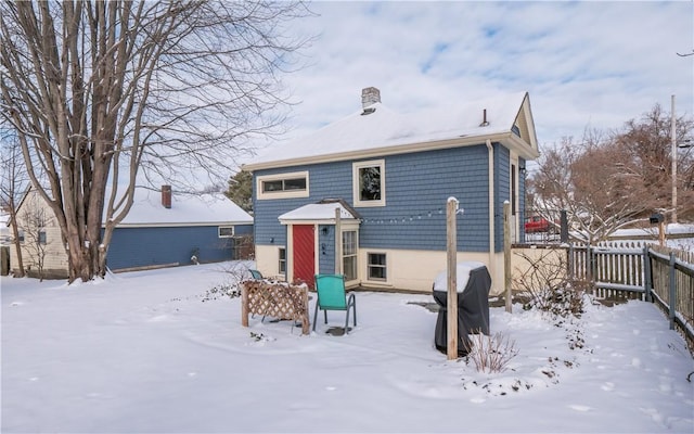 view of snow covered rear of property