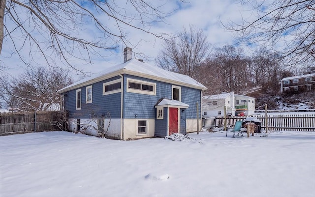 view of snow covered rear of property