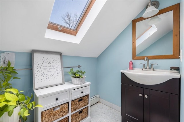 bathroom featuring vanity, vaulted ceiling with skylight, and baseboard heating