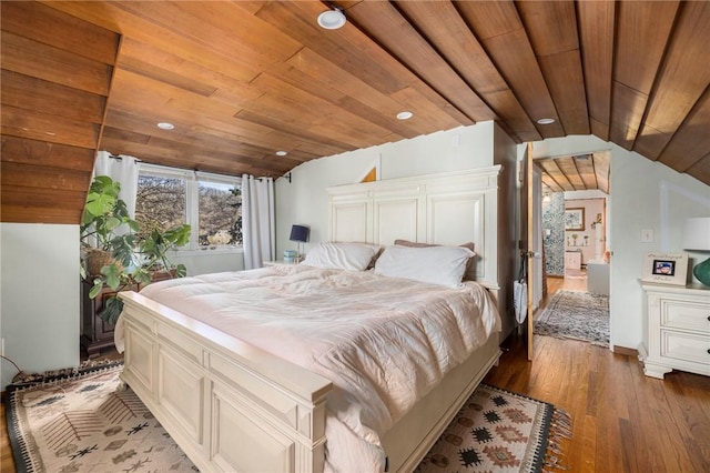 bedroom with vaulted ceiling, hardwood / wood-style floors, and wood ceiling