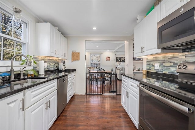 kitchen featuring stainless steel appliances, sink, dark wood-type flooring, and white cabinets