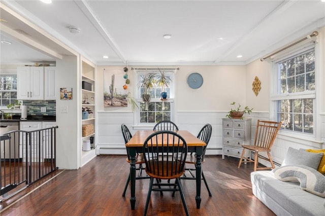 dining space with beamed ceiling, a baseboard radiator, and dark hardwood / wood-style floors