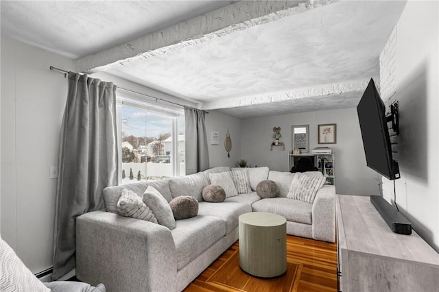 living room featuring hardwood / wood-style floors and a baseboard heating unit