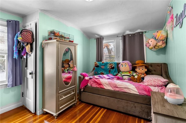 bedroom with dark hardwood / wood-style flooring