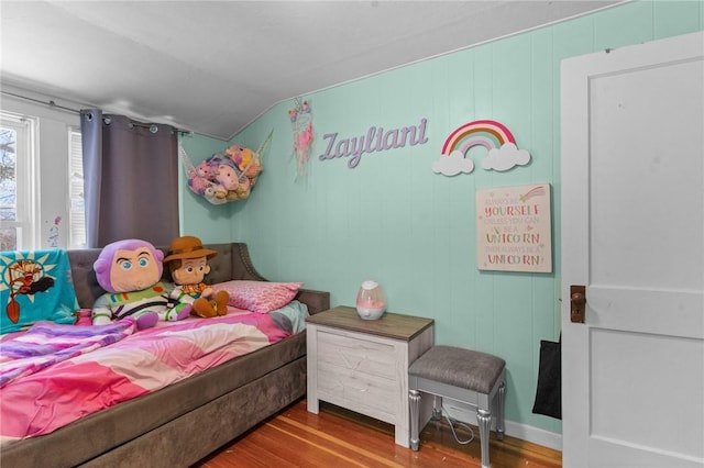 bedroom featuring lofted ceiling and hardwood / wood-style floors