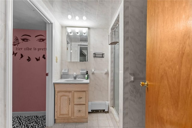 bathroom with tile patterned floors, an enclosed shower, and vanity