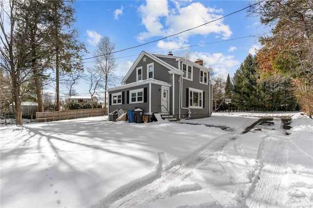 view of snow covered rear of property