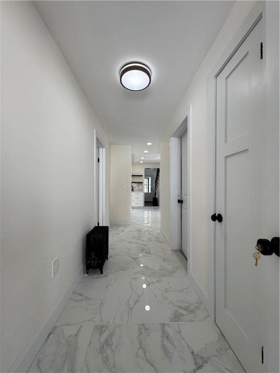 hall with marble finish floor, baseboards, and recessed lighting