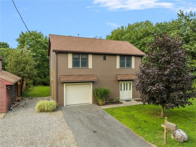 view of front of property with a garage and a front yard