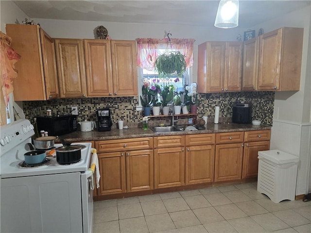 kitchen featuring sink, white electric range, light tile patterned flooring, and backsplash