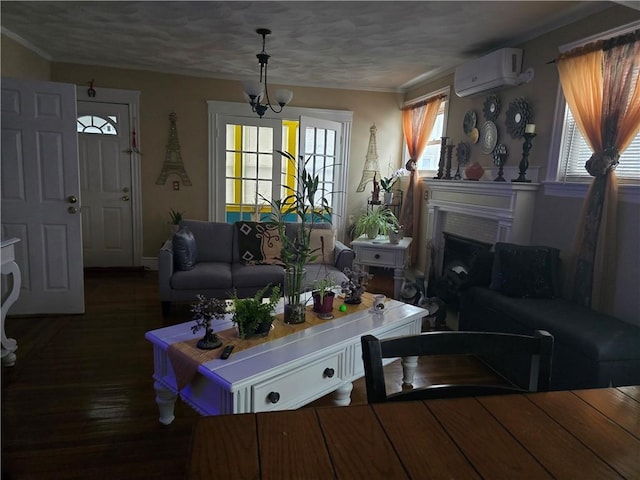 living room with plenty of natural light, dark wood-type flooring, a notable chandelier, and a wall unit AC