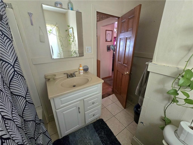 bathroom featuring walk in shower, tile patterned floors, vanity, and toilet