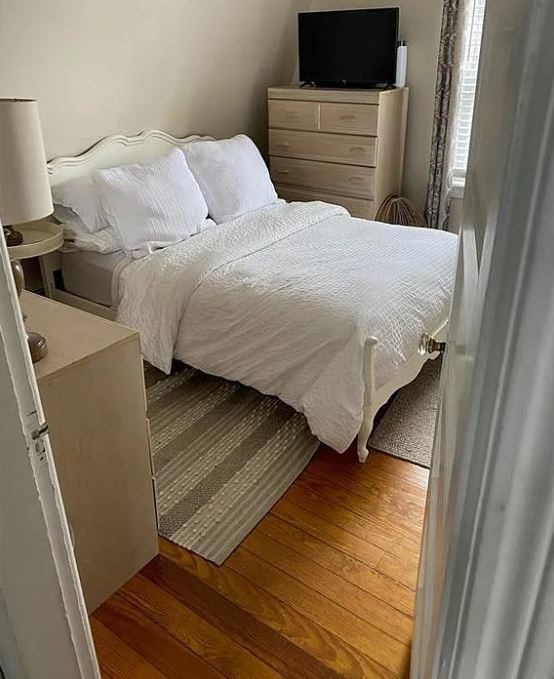 bedroom with dark hardwood / wood-style flooring