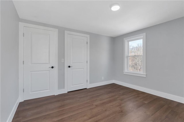 unfurnished bedroom featuring dark hardwood / wood-style floors