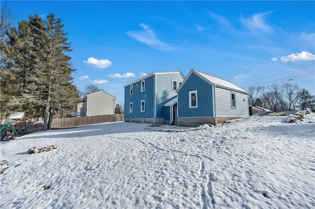 view of snow covered back of property