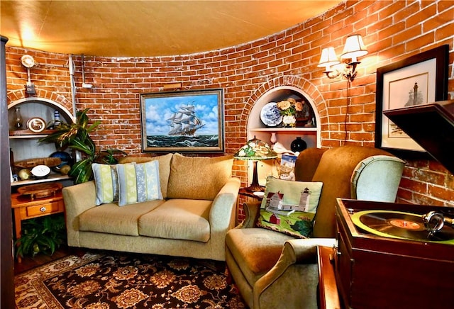 living room featuring brick wall