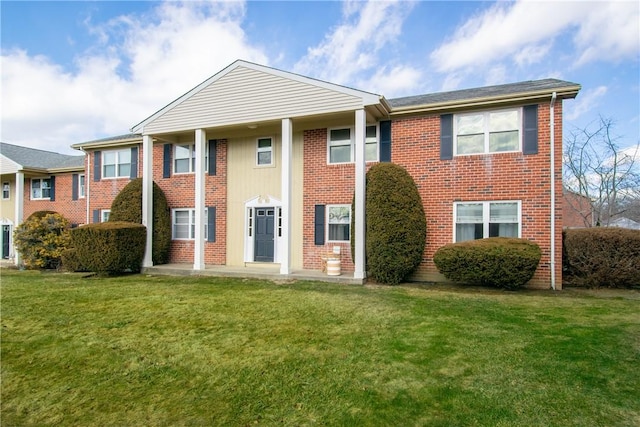 view of front of house with brick siding and a front yard