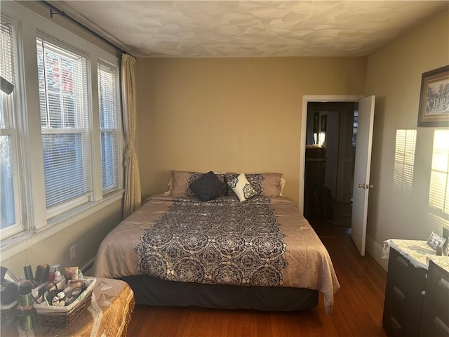 bedroom with dark wood finished floors