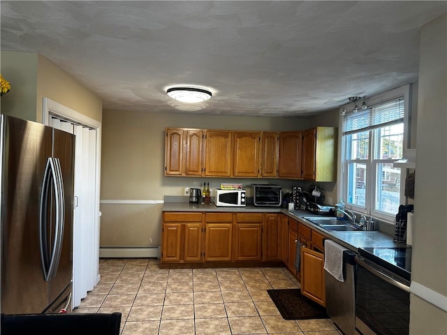 kitchen with dishwashing machine, white microwave, range with electric cooktop, a sink, and freestanding refrigerator