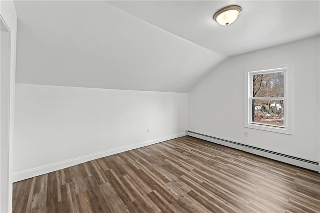 bonus room with a baseboard heating unit, vaulted ceiling, and hardwood / wood-style floors