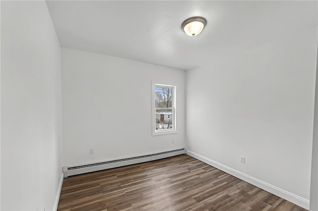 unfurnished room with a baseboard radiator and dark hardwood / wood-style floors