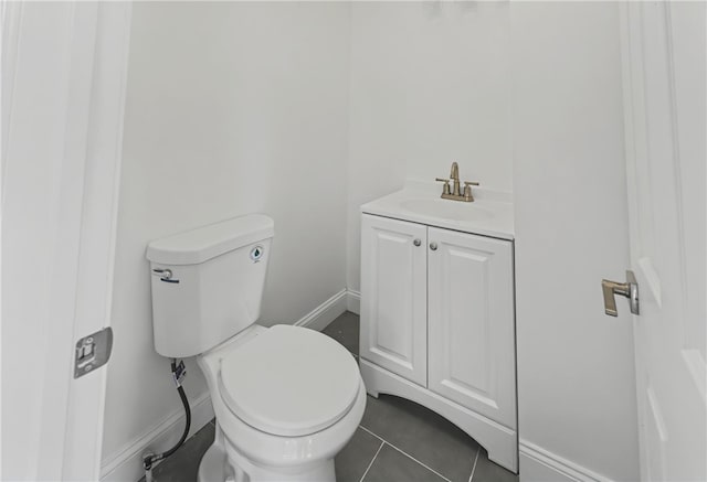 bathroom featuring tile patterned floors, vanity, and toilet