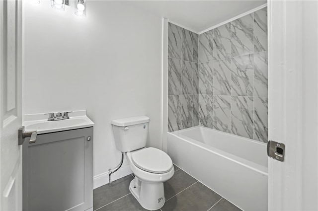 full bathroom featuring vanity, tiled shower / bath, tile patterned floors, and toilet