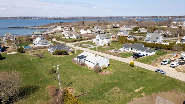 drone / aerial view featuring a residential view and a water view