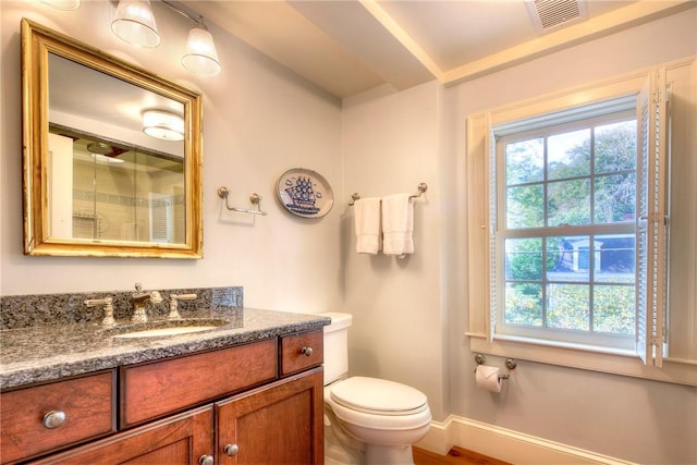 bathroom featuring vanity and toilet