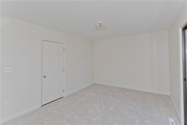 empty room with light carpet and baseboards