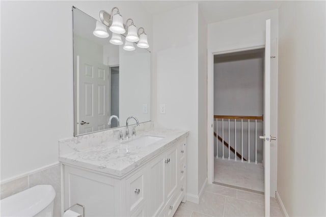 bathroom featuring a chandelier, tile patterned flooring, vanity, and toilet