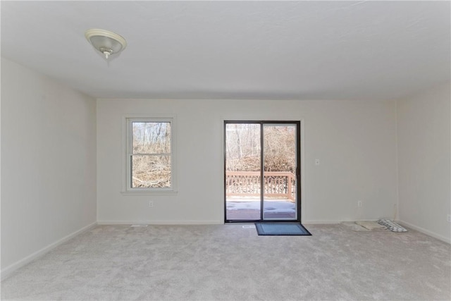 spare room with carpet flooring and baseboards