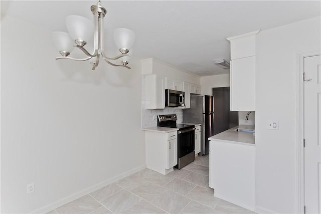 kitchen featuring a sink, white cabinets, light countertops, appliances with stainless steel finishes, and tasteful backsplash