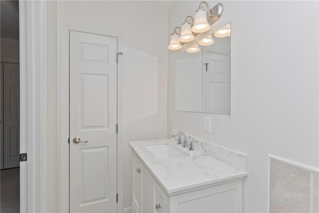 bathroom featuring a chandelier and vanity