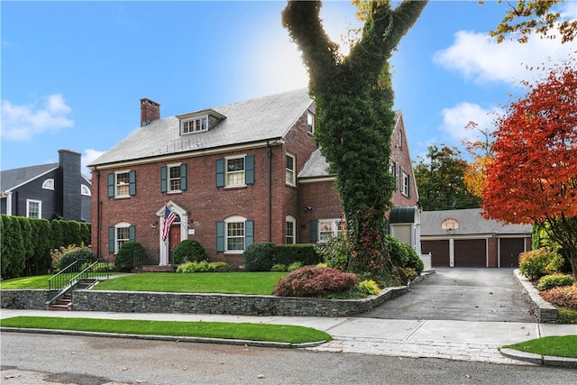 colonial-style house with a front lawn and a garage