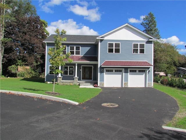 view of front of home with a garage and a front lawn