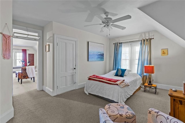 carpeted bedroom with a ceiling fan, lofted ceiling, and baseboards