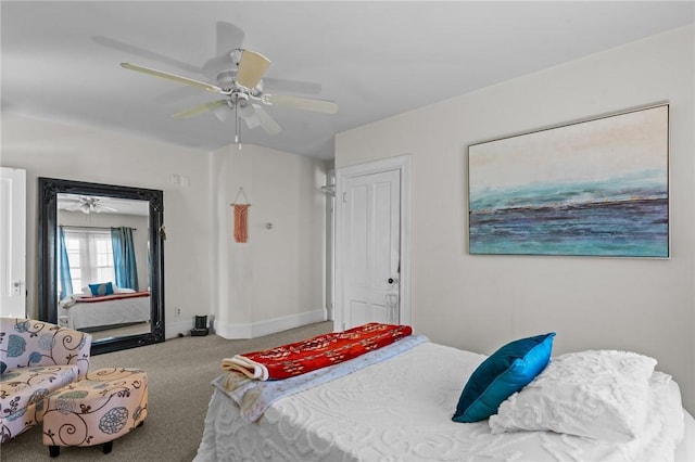 carpeted bedroom with ceiling fan and baseboards