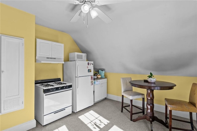 kitchen with light colored carpet, vaulted ceiling, white appliances, under cabinet range hood, and baseboards