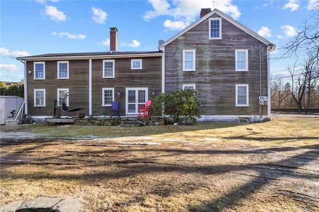 back of property with a chimney