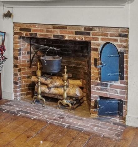 interior details with a fireplace and wood finished floors