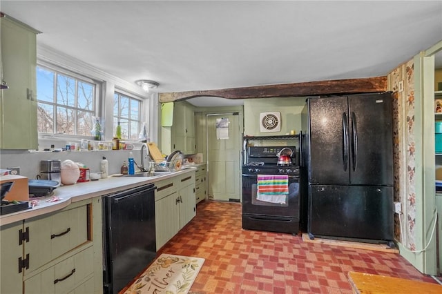 kitchen with light floors, light countertops, a sink, and black appliances