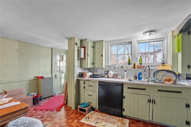 kitchen with dishwasher, light countertops, a sink, and green cabinetry