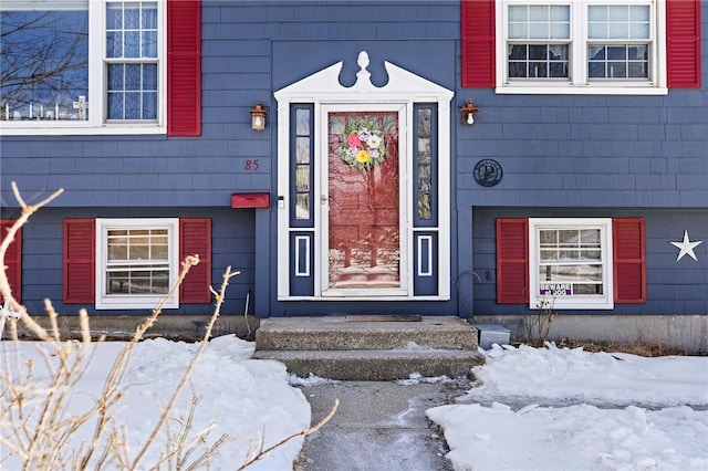 view of snow covered property entrance