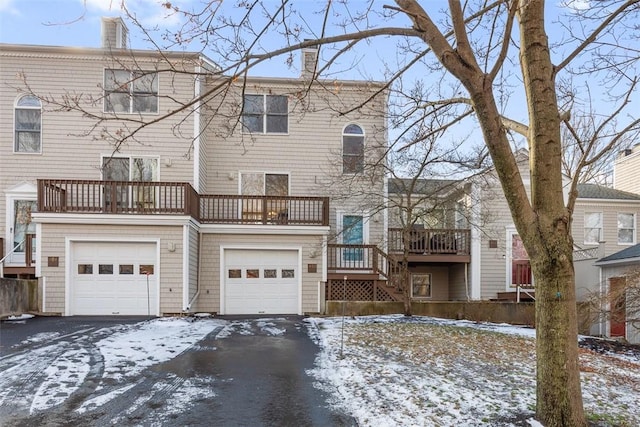 view of front of house featuring a balcony and a garage