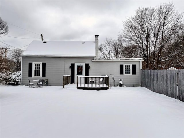 snow covered property with a deck